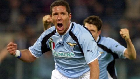 Lazio's Diego Simeone of Argentina celebrates after kicking a ball that was knocked into Parma's goal by Parma's captain Lilian Thuram of France during their Italian Serie A top league match in Rome's Olympic stadium, Wednesday, April, 18, 2001. Player at right is Lazio's Paolo Negro of Italy. (AP Photo/Andrew Medichini)