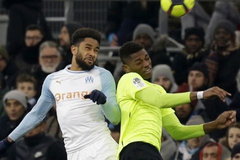 Marseille's Jordan Amavi, left, battles for the ball with Lille's Rafael Leao during a French League One soccer match between Olympique Marseille and Lille at the Stade Velodrome in Marseille, France, Friday, Jan. 25, 2019. (AP Photo/Claude Paris)
