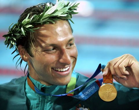 ** FILE ** Ian Thorpe, of Australia, smiles with his gold medal after winning the 200-meter freestyle at the Olympic Aquatic Centre during the 2004 Olympic Games in Athens, in this August 16, 2004, file photo. Five-time Olympic champion Ian Thorpe has quit competitive swimming. Thorpe, 24, held a news conference Tuesday November 21, 2006, to announce his decision at a downtown Sydney hotel. (AP Photo/Mark J. Terrill, FILE)