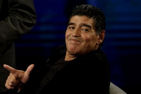 Argentine's former soccer Diego Armando Maradona watches as he attends the Italian TV state program 'Che tempo che fa', in Milan, Italy, Sunday, Oct. 20, 2013. Italy's tax collection agency says it has formally notified Diego Maradona that it will begin procedures to freeze his assets in Italy to pay off his tax debt of $53 million. Equitalia confirmed news reports Friday saying its agents had served Maradona with the notification in his Milan hotel room, and that he signed the documentation. The Argentine great is in Italy to promote a video series on his life and watched his former club Napoli play Roma on Friday. (AP Photo/Luca Bruno)