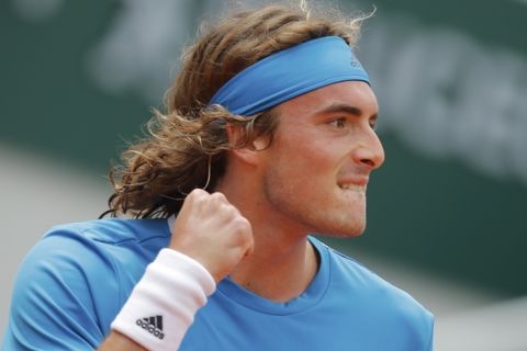 Greece's Stefanos Tsitsipas clenches his fist after scoring a point against Germany's Maximilian Marterer during their first round match of the French Open tennis tournament at the Roland Garros stadium in Paris, Sunday, May 26, 2019. (AP Photo/Michel Euler )