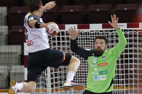 Germany's Uwe Gensheimer (L) in action against Slovenia's goalkeeper Primoz Prost during the Qatar 2015 24th Men's Handball World Championship match for the 7th place between Germany and Slovenia at the Lusail Multipurpose Hall outside Doha, Qatar, 31 January 2015. Qatar 2015 via epa/Robert Ghement