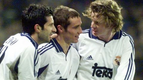 Real Madrid's English player Steve McManaman, right, and Luis Figo, left, of Portugal, congratulate Spanish midfielder Ivan Helguera after he scored a goal against crosstown rival Rayo Vallecano in a Spanish league soccer match in Real's Santiago Bernabeu stadium Tuesday, Dec. 19, 2000, in Madrid. Real won the match 3-1. (AP Photo/Ruben Mondelo)