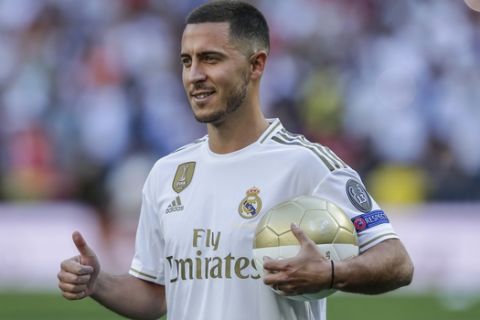 Belgium forward Eden Hazard poses for the media during his official presentation after signing for Real Madrid at the Santiago Bernabeu stadium in Madrid, Spain, Thursday, June 13, 2019. Real Madrid announced last week that it had acquired the 28-year-old Belgian playmaker from Chelsea for a reported fee of around 100 million euros ($113 million) plus variables, making him the club's most expensive signing ever. (AP Photo/Manu Fernandez)