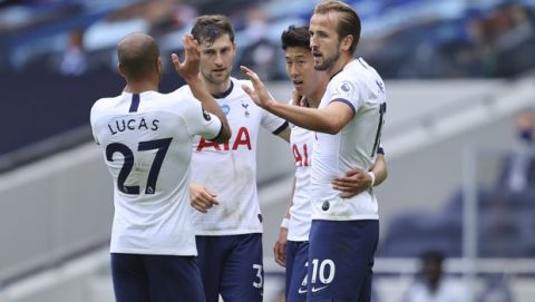 Tottenham's Harry Kane, right, celebrates after scoring his side's second goal during the English Premier League soccer match between Tottenham Hotspur and Leicester City, at the Tottenham Hotspur Stadium in London, Sunday, July 19, 2020. (Richard Heathcote/Pool Photo via AP)