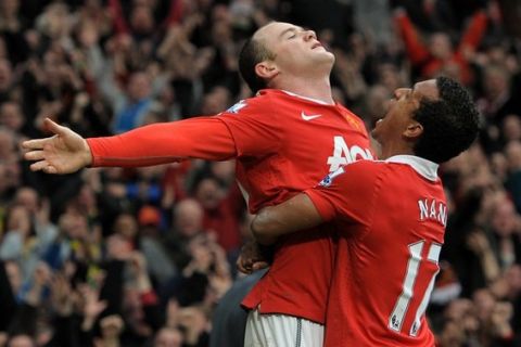 Manchester United's English striker Wayne Rooney (L) celebrates with Portuguese midfielder Nani after scoring their second goal during the English Premier League football match between Manchester United and Manchester City at Old Trafford in Manchester, north-west England on February 12, 2011. AFP PHOTO/ANDREW YATESRESTRICTED TO EDITORIAL USE Additional licence required for any commercial/promotional use or use on TV or internet (except identical online version of newspaper) of Premier League/Football League photos. Tel DataCo +44 207 2981656. Do not alter/modify photo (Photo credit should read ANDREW YATES/AFP/Getty Images)