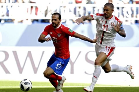 Costa Rica's Marcos Urena, let, vies for the ball with Serbia's Aleksandar Kolarov during the group E match between Costa Rica and Serbia at the 2018 soccer World Cup in the Samara Arena in Samara, Russia, Sunday, June 17, 2018. (AP Photo/Natacha Pisarenko)