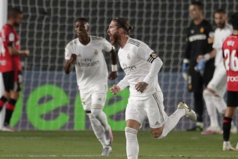 Real Madrid's Sergio Ramos celebrates after scoring his side's second goal during the Spanish La Liga soccer match between Real Madrid and Mallorca at Alfredo di Stefano stadium in Madrid, Spain, Wednesday, June 24, 2020. (AP Photo/Bernat Armangue)