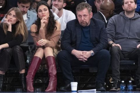 Executive chairman and Madison Square Garden CEO James Dolan, second from right, watches the game action in the second half of an NBA basketball game between the New York Knicks and the Indiana Pacers, Saturday, Dec. 7, 2019, at Madison Square Garden in New York. The Pacers won 104-103. (AP Photo/Mary Altaffer)