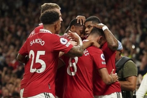 Manchester United's Marcus Rashford celebrates with his teammates after scoring his side's second goal during the English Premier League soccer match between Manchester United and Liverpool at Old Trafford stadium, in Manchester, England, Monday, Aug 22, 2022. (AP Photo/Dave Thompson)