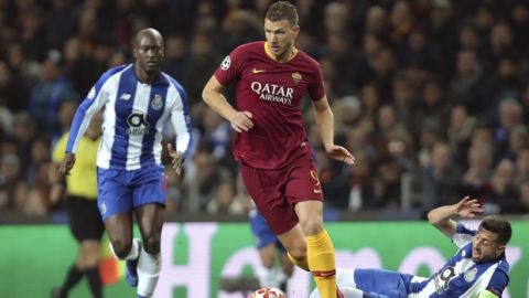 Roma forward Edin Dzeko runs with the ball away from Porto midfielder Hector Herrera, right, during the Champions League round of 16, 2nd leg, soccer match between FC Porto and AS Roma at the Dragao stadium in Porto, Portugal, Wednesday, March 6, 2019. (AP Photo/Luis Vieira)