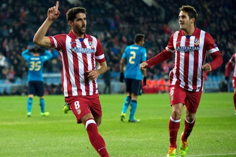 MADRID, SPAIN - DECEMBER 11:  Raul Garcia (L) celebrates scoring their opening goal with teammate Koke (R) during the UEFA Champions League Group G match at Vicente Calderon Stadium on December 11, 2013 in Madrid, Spain.  (Photo by Gonzalo Arroyo Moreno/Getty Images)