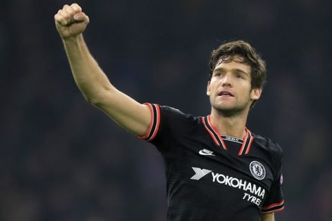 Chelsea's Marcos Alonso celebrates at the end of the group H Champions League soccer match between Ajax and Chelsea at the Johan Cruyff ArenA in Amsterdam, Netherlands, Wednesday, Oct. 23, 2019. Chelsea won 1:0. (AP Photo/Peter Dejong)