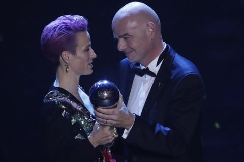 United States forward Megan Rapinoe receives the Best FIFA Women's player award from FIFA president Gianni Infantino during the ceremony of the Best FIFA Football Awards, in Milan's La Scala theater, northern Italy, Monday, Sept. 23, 2019. (AP Photo/Antonio Calanni)