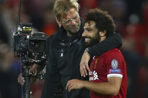 Liverpool's manager Juergen Klopp hugs Liverpool's Mohamed Salah at the end of the Champions League qualifying play-off second leg soccer match between Liverpool and Hoffenheim at Anfield stadium in Liverpool, England, Wednesday, Aug. 23, 2017. Liverpool won the match 4-2 (6-3 on aggregate). (AP Photo/Dave Thompson)