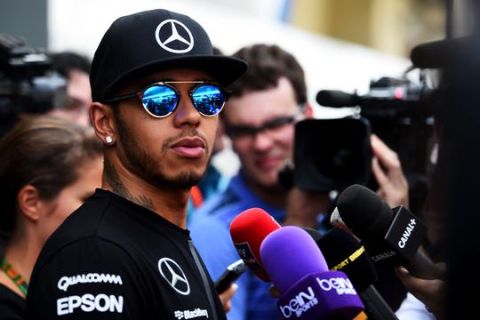 SAO PAULO, BRAZIL - NOVEMBER 12:  Lewis Hamilton of Great Britain and Mercedes GP speaks with members of the media in the paddock during previews for the Formula One Grand Prix of Brazil at Autodromo Jose Carlos Pace on November 12, 2015 in Sao Paulo, Brazil.  (Photo by Lars Baron/Getty Images)