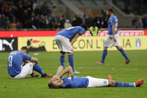Italian players react to their elimination at the end of the World Cup qualifying play-off second leg soccer match between Italy and Sweden, at the Milan San Siro stadium, Italy, Monday, Nov. 13, 2017. (AP Photo/Luca Bruno)