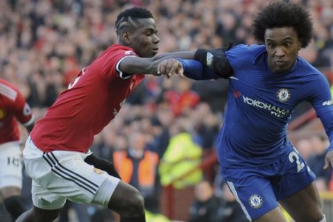 Chelsea's Willian, right, challenges for the ball with Manchester United's Paul Pogba during the English Premier League soccer match between Manchester United and Chelsea at the Old Trafford stadium in Manchester, England, Sunday, Feb. 25, 2018. (AP Photo/Rui Vieira)