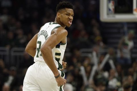Milwaukee Bucks' Giannis Antetokounmpo reacts after a dunk during the first half of an NBA basketball game against the Utah Jazz Monday, Nov. 25, 2019, in Milwaukee. (AP Photo/Aaron Gash)