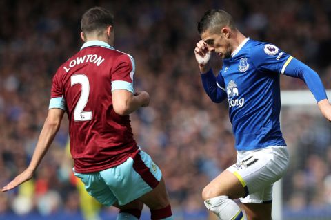 Everton's Kevin Mirallas, right, and Burnley's Matthew Lowton battle for the ball during their English Premier League soccer match at Goodison Park, Liverpool, England, Saturday, April 15, 2017. (Martin Rickett/PA via AP)