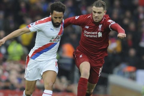 Crystal Palace's Andros Townsend, left, and Liverpool's Jordan Henderson challenge for the ball during the English Premier League soccer match between Liverpool and Crystal Palace at Anfield in Liverpool, England, Saturday, Jan. 19, 2019. (AP Photo/Rui Vieira)