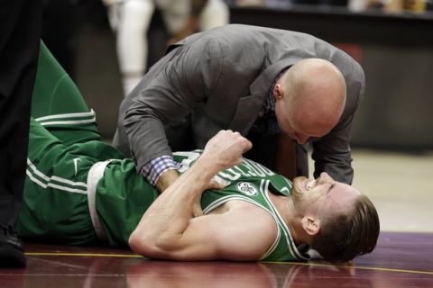 Boston Celtics' Gordon Hayward grimaces in pain in the first half of an NBA basketball game against the Cleveland Cavaliers, Tuesday, Oct. 17, 2017, in Cleveland. Just five minutes into his Boston career, new Celtics star forward Gordon Hayward gruesomely broke his left ankle, an injury that may end his season. (AP Photo/Tony Dejak)