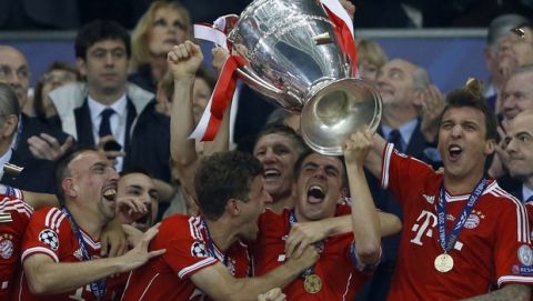Bayern's Philipp Lahm holds up the trophy after his side won the Champions League Final soccer match against Borussia Dortmund, at Wembley Stadium in London, Saturday May 25, 2013.  (AP Photo/Kirsty Wigglesworth)