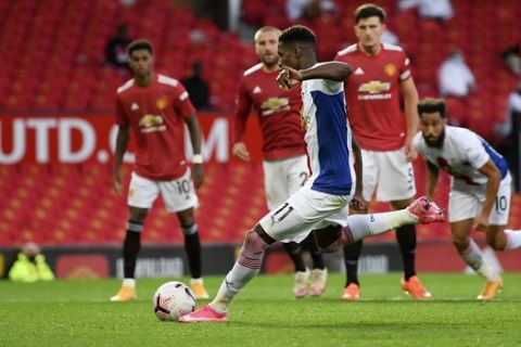 Crystal Palace's Wilfried Zaha scores his side's second goal during the English Premier League soccer match between Manchester United and Crystal Palace at the Old Trafford stadium in Manchester, England, Saturday, Sept. 19, 2020. (Shaun Botterill/Pool via AP)