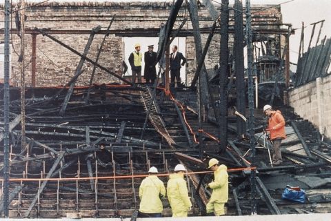 Forensic experts and police comb through the charred remains of a wooden soccer stand at Bradford's Valley Parade football ground in England in May 1985, after a fire had raged during a match on May 11, resulting in 53 deaths and many injuries. The fire, fanned by a strong wind, quickly swept through the stand in minutes, trapping many of the victims. (AP Photo/John Redman)