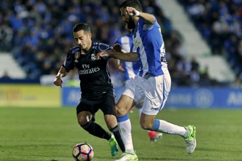 Real Madrid's Lucas Vazquez, left, vies for the ball with Leganes' Dimitrios Siovas during a Spanish La Liga soccer match between Leganes and Real Madrid at the Butarque stadium in Madrid, Wednesday, April 5, 2017. (AP Photo/Francisco Seco)