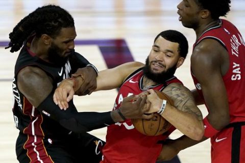 Miami Heat's Jae Crowder, left, battles Toronto Raptors' Fred VanVleet for the ball during the second half of an NBA basketball game Monday, Aug. 3, 2020, in Lake Buena Vista, Fla. (AP Photo/Ashley Landis, Pool)