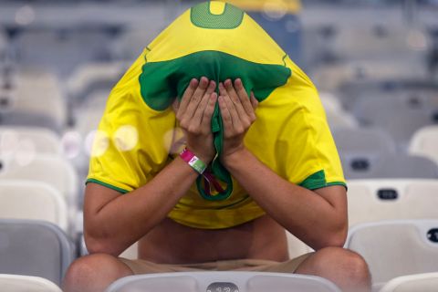 A Brazil fan covers his face after the World Cup semifinal soccer match between Brazil and Germany at the Mineirao Stadium in Belo Horizonte, Brazil, Tuesday, July 8, 2014. Germany beat Brazil 7-1 and advanced to the final.  (AP Photo/Frank Augstein)