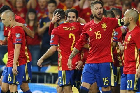 Spain's Isco, background center, celebrates after scoring his side's second goal during the World Cup Group G qualifying soccer match between Spain and Italy at the Santiago Bernabeu Stadium in Madrid, Saturday Sept. 2, 2017. (AP Photo/Paul White)