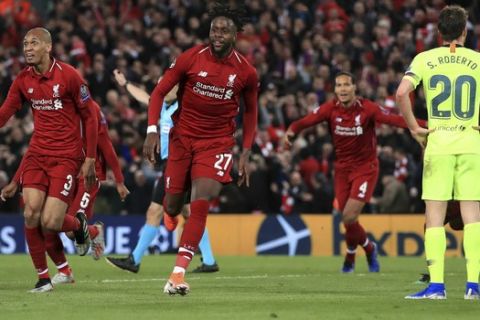 Liverpool's Divock Origi, center, celebrates scoring his side's fourth goal of the game during the Champions League Semi Final, second leg soccer match between Liverpool and Barcelona at Anfield, Liverpool, England, Tuesday, May 7, 2019. (Peter Byrne/PA via AP)