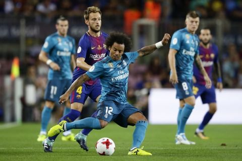 Real Madrid's Marcelo duels for the ball during the Spanish Supercup, first leg, soccer match between FC Barcelona and Real Madrid at the Camp Nou stadium in Barcelona, Spain, Sunday, Aug. 13, 2017. (AP Photo/Manu Fernandez)
