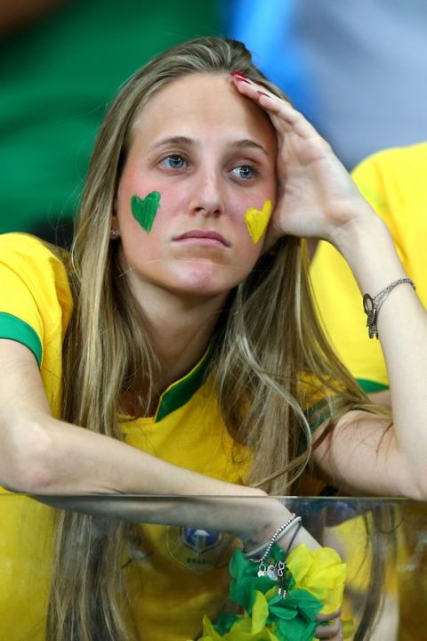 BELO HORIZONTE, BRAZIL - JULY 08:  A Brazil fan looks dejected during the 2014 FIFA World Cup Brazil Semi Final match between Brazil and Germany at Estadio Mineirao on July 8, 2014 in Belo Horizonte, Brazil.  (Photo by Martin Rose/Getty Images)