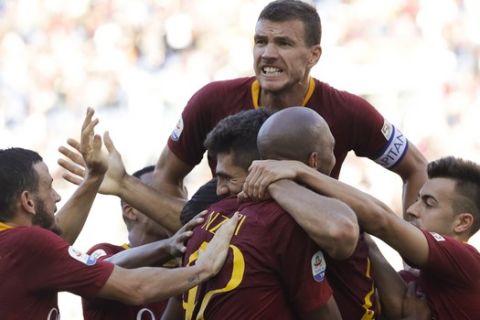 Roma's Edin Dzeko, top, and teammates celebrate after Federico Fazio, foreground center, scored his side's 3rd goal, during the Serie A soccer match between Roma and Lazio, at the Rome Olympic Stadium, Saturday, Sept. 29, 2018. Roma turns in its most convincing performance of the season, beating rival Lazio 3-1 in the all-important Rome derby. (AP Photo/Andrew Medichini)
