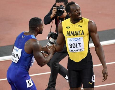 United States' Justin Gatlin, left, is congratulated by third placed Jamaica's Usain Bolt after winning the Men's 100 meters final during the World Athletics Championships in London Saturday, Aug. 5, 2017. (AP Photo/Martin Meissner)
