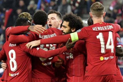 Liverpool's Naby Keita, left, celebrates with teammates after scoring his side's opening goal during the group E Champions League soccer match between Salzburg and Liverpool, in Salzburg, Austria, Tuesday, Dec. 10, 2019. (AP Photo/Kerstin Joensson)