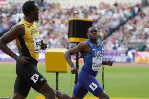 Jamaica's Usain Bolt, left, looks across at United States' Christian Coleman as they race in a Men's 100m semifinal during the World Athletics Championships in London Saturday, Aug. 5, 2017. (AP Photo/Kirsty Wigglesworth)