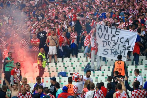 A flare burns after it is set off amongst the Croatia fans.
