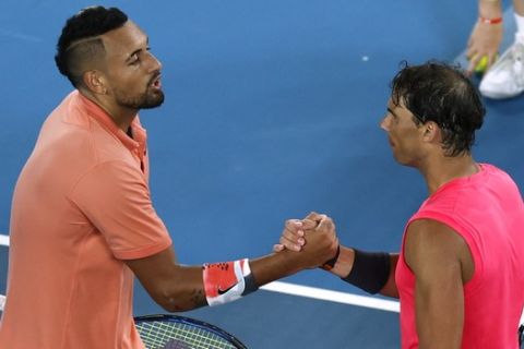Spain's Rafael Nadal, right, is congratulated by Australia's Nick Kyrgios after winning their fourth round singles match at the Australian Open tennis championship in Melbourne, Australia, Monday, Jan. 27, 2020.(AP Photo/Andy Wong)