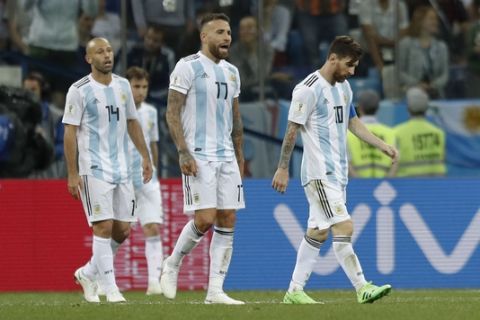 From left, Argentina's Javier Mascherano, Nicolas Otamendi and Lionel Messi leave the pitch at the end of the group D match between Argentina and Croatia at the 2018 soccer World Cup in Nizhny Novgorod Stadium in Novgorod, Russia, Thursday, June 21, 2018. Croatia won 3-0. (AP Photo/Pavel Golovkin)