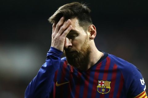 Barcelona forward Lionel Messi touches his face during the Spanish La Liga soccer match between Real Madrid and FC Barcelona at the Bernabeu stadium in Madrid, Saturday, March 2, 2019. (AP Photo/Manu Fernandez)