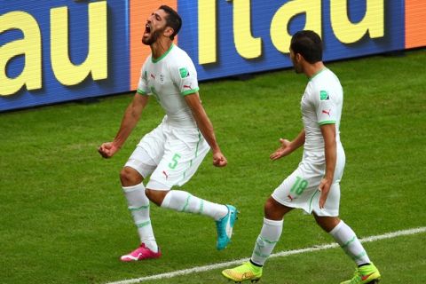 PORTO ALEGRE, BRAZIL - JUNE 22:  Rafik Halliche of Algeria celebrates after scoring his team's second goal during the 2014 FIFA World Cup Brazil Group H match between South Korea and Algeria at Estadio Beira-Rio on June 22, 2014 in Porto Alegre, Brazil.  (Photo by Paul Gilham/Getty Images)
