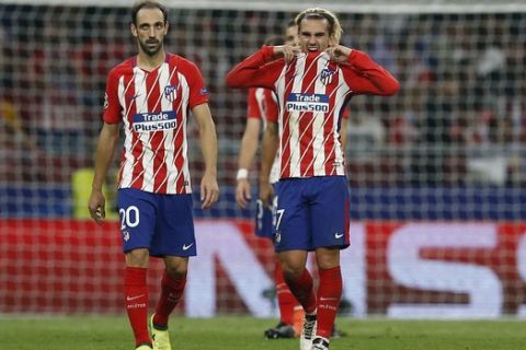 Atletico's Antoine Griezmann, right, and his teammate Juanfran react during a Group C Champions League soccer match between Atletico Madrid and Chelsea at the Wanda Metropolitano stadium in Madrid, Spain, Wednesday Sept. 27, 2017. Chelsea won 2-1.(AP Photo/Paul White)