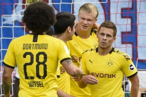 Dortmund's Erling Braut Haaland, second from right, celebrates with his teammates after he scored his side's first goal during the German Bundesliga soccer match between RB Leipzig and Borussia Dortmund in Leipzig, Germany, Saturday, June 20, 2020. (AP Photo/Jens Meyer, Pool)