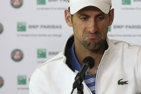 Serbia's Novak Djokovic grimaces during a press conference after losing to Austria's Dominic Thiem in a quarterfinal match of the French Open tennis tournament at the Roland Garros stadium, Wednesday, June 7, 2017 in Paris. (AP Photo/David Vincent)
