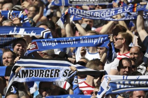 Hamburg fans support their team  during the German Bundesliga soccer match between Hamburger SV and SC Freiburg, in Hamburg, Germany, Saturday, April 21, 2018. (Christian Charisius/dpa via AP)