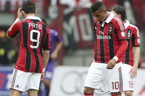 AC Milan midfielder Kevin Prince Boateng, right, of Ghana, reacts with his teammates Brazilian forward Pato after Fiorentina midfielder Alberto Aquilani scored during the Serie A soccer match between AC Milan and Fiorentina at the San Siro stadium in Milan, Italy, Sunday, Nov. 11, 2012. (AP Photo/Antonio Calanni)